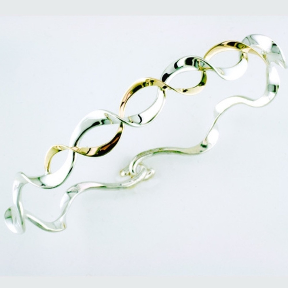 Tom Kruskal A ribbon of a solid 14k gold entwines this silver ruffle bracelet